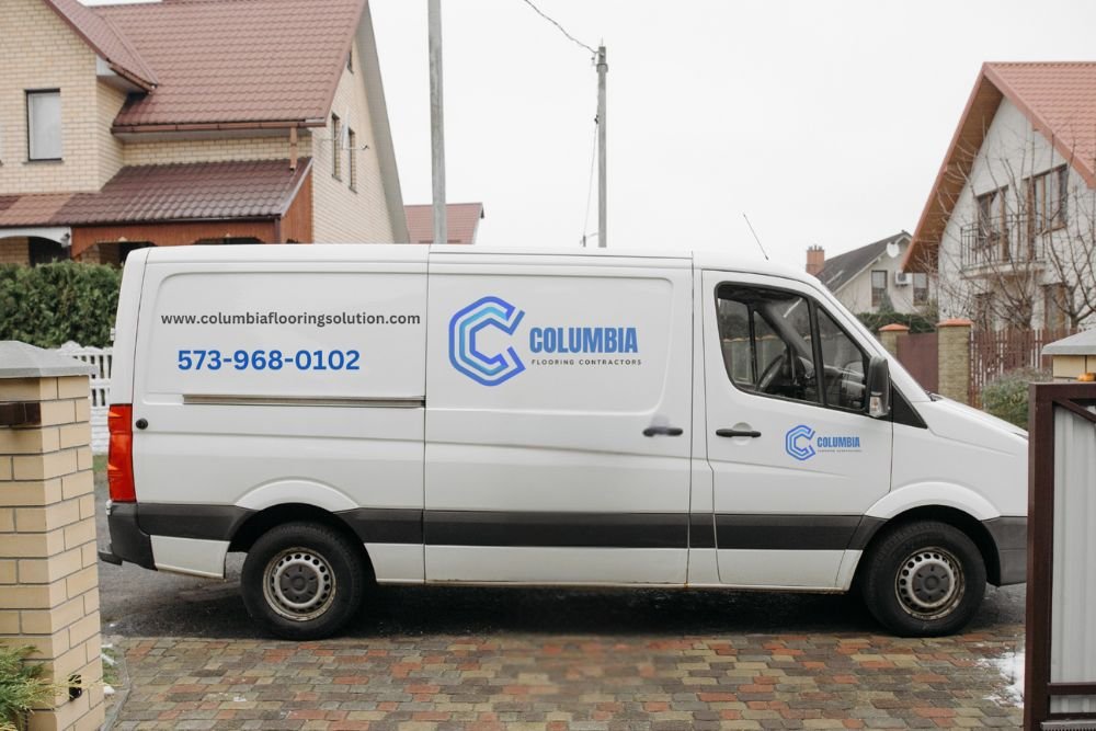 A white van stands in front of a house, showcasing flooring services offered in Columbia, SC.