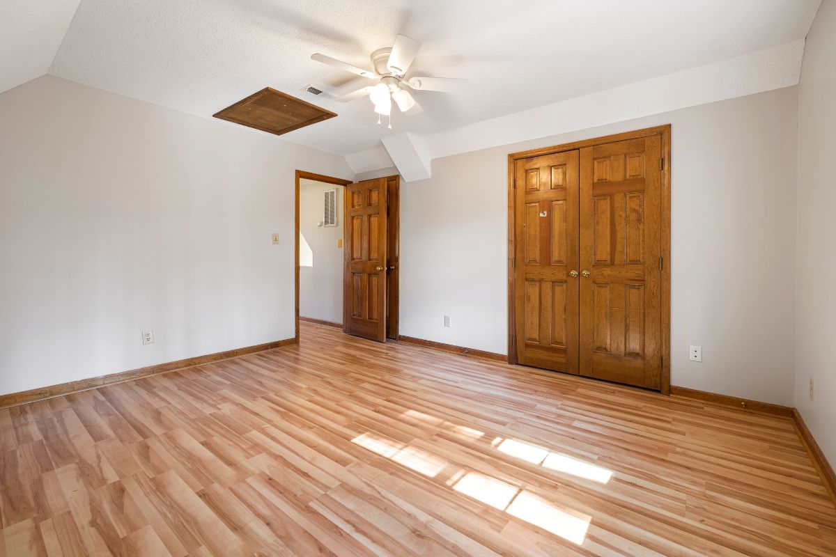 A cozy room featuring hardwood floors and a ceiling fan, creating a warm and inviting atmosphere.